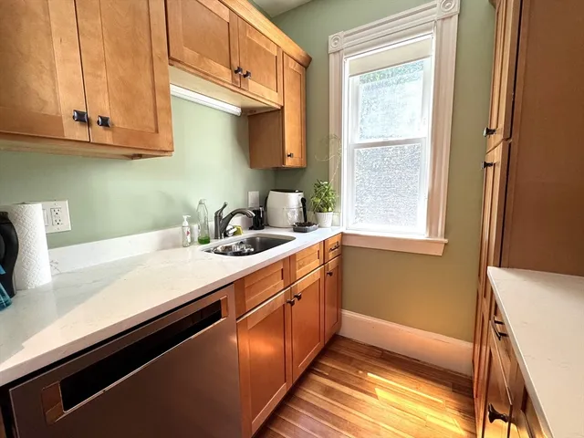 a kitchen with sink cabinets and a window