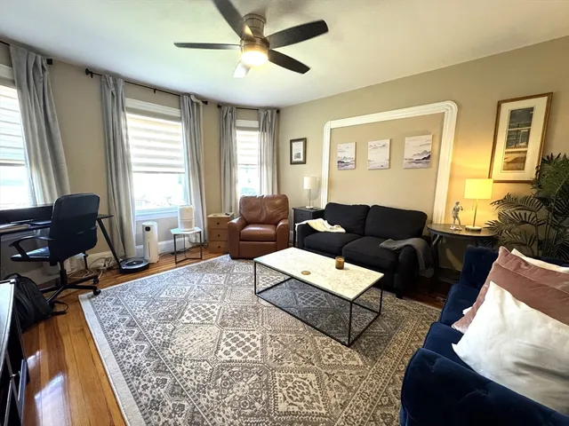 a living room with furniture rug and window