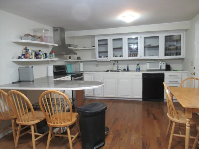 a kitchen with a table chairs stove and cabinets