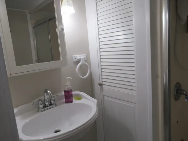 a bathroom with a sink and a mirror