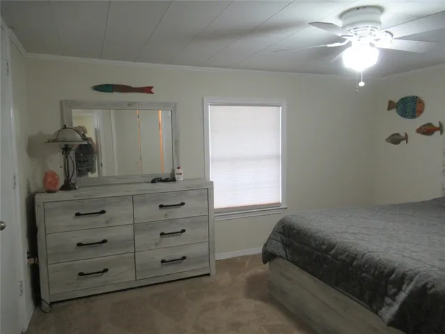 a bedroom with a bed and a dresser