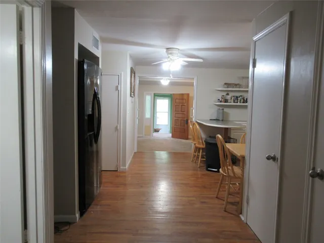a view of a hallway with wooden floor windows and livingroom