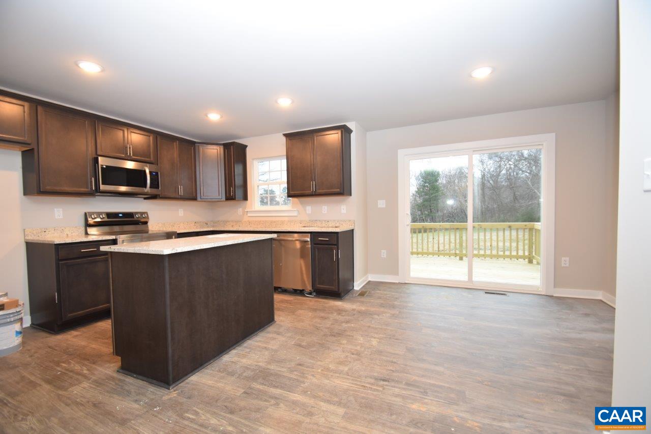 1140 Hanback Road Gordonsville, VA 22942 - Photo 5 of 16 a kitchen with kitchen island granite countertop a stove top oven a sink a counter top space cabinets and a window