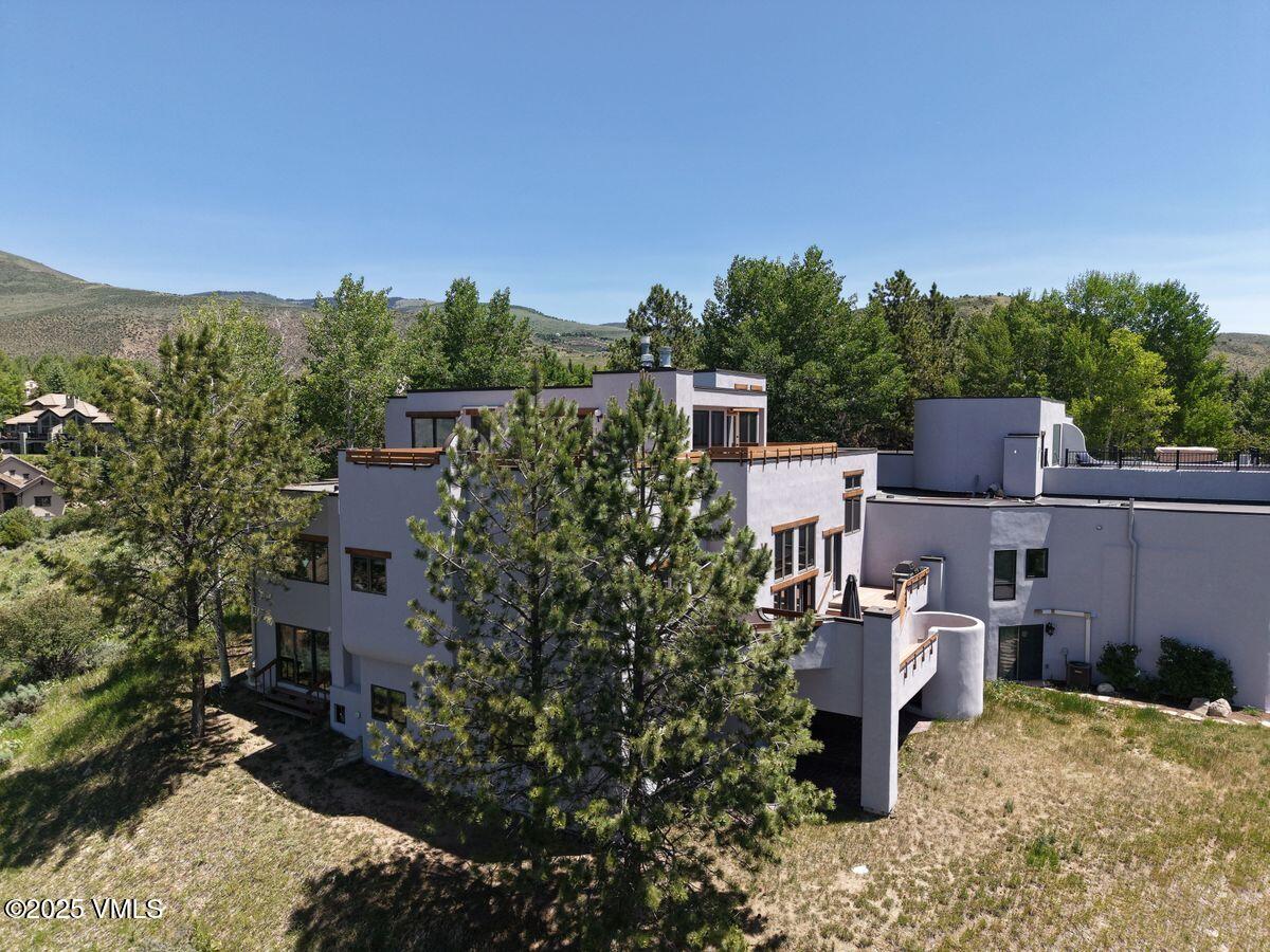 141 Corral Road, Unit A Edwards, CO 81632 - Photo 16 of 51 a backyard of a house with table and chairs
