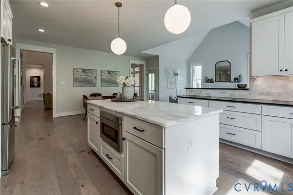 a bathroom with a sink a light fixture and a mirror