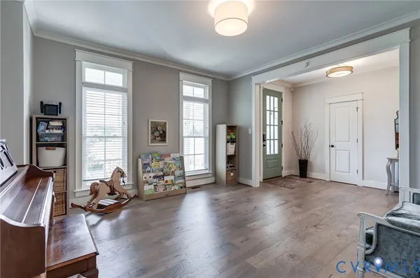 a living room with furniture and a wooden floor