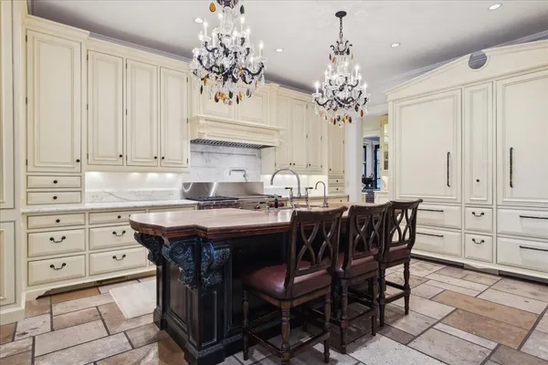 a kitchen with stainless steel appliances kitchen island granite countertop a stove a sink and a refrigerator