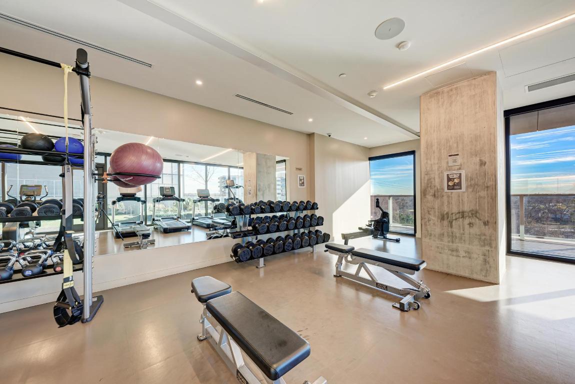 48 East Avenue, Unit 2802 Austin, TX 78701 - Photo 26 of 38 a room with gym equipment and a table