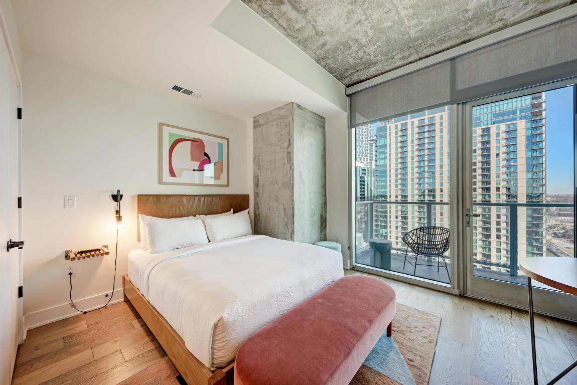 48 East Avenue, Unit 2802 Austin, TX 78701 - Photo 7 of 38 a bedroom with a bed and a large window