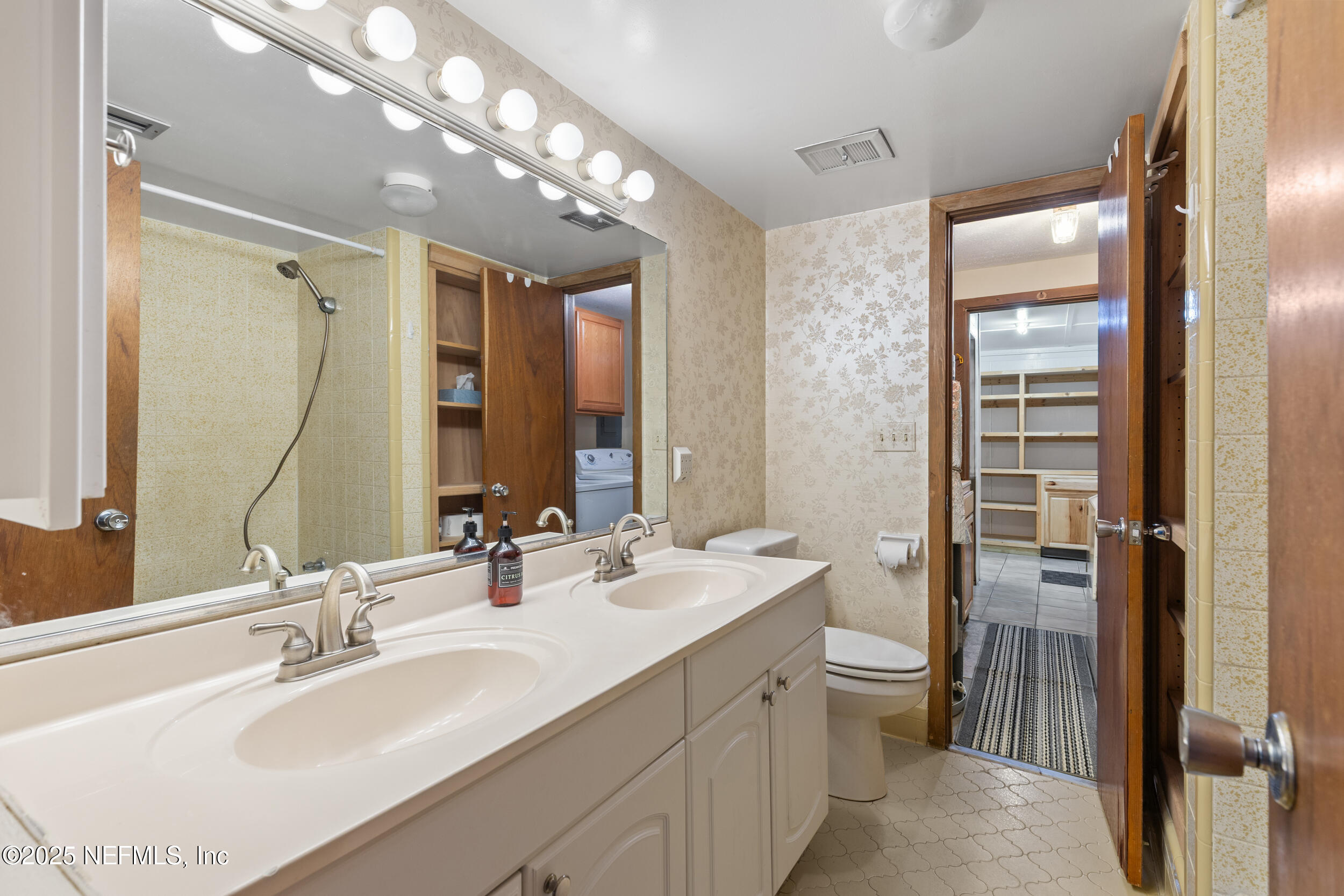 6441 Baker Road Keystone Heights, FL 32656 - Photo 15 of 66 a bathroom with a double vanity sink mirror and double