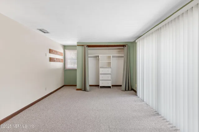 a living room with furniture and a dining table