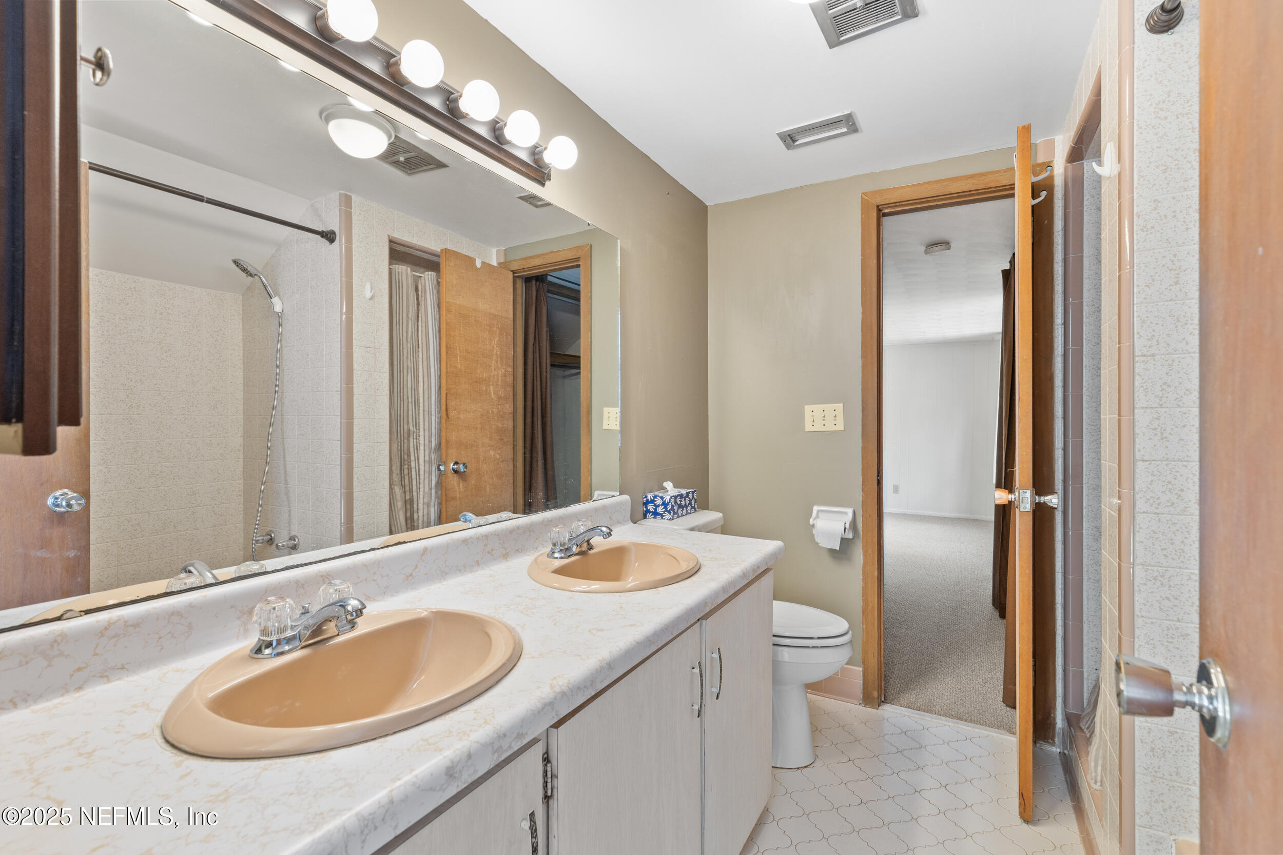 6441 Baker Road Keystone Heights, FL 32656 - Photo 19 of 66 a bathroom with a sink double vanity granite and a mirror