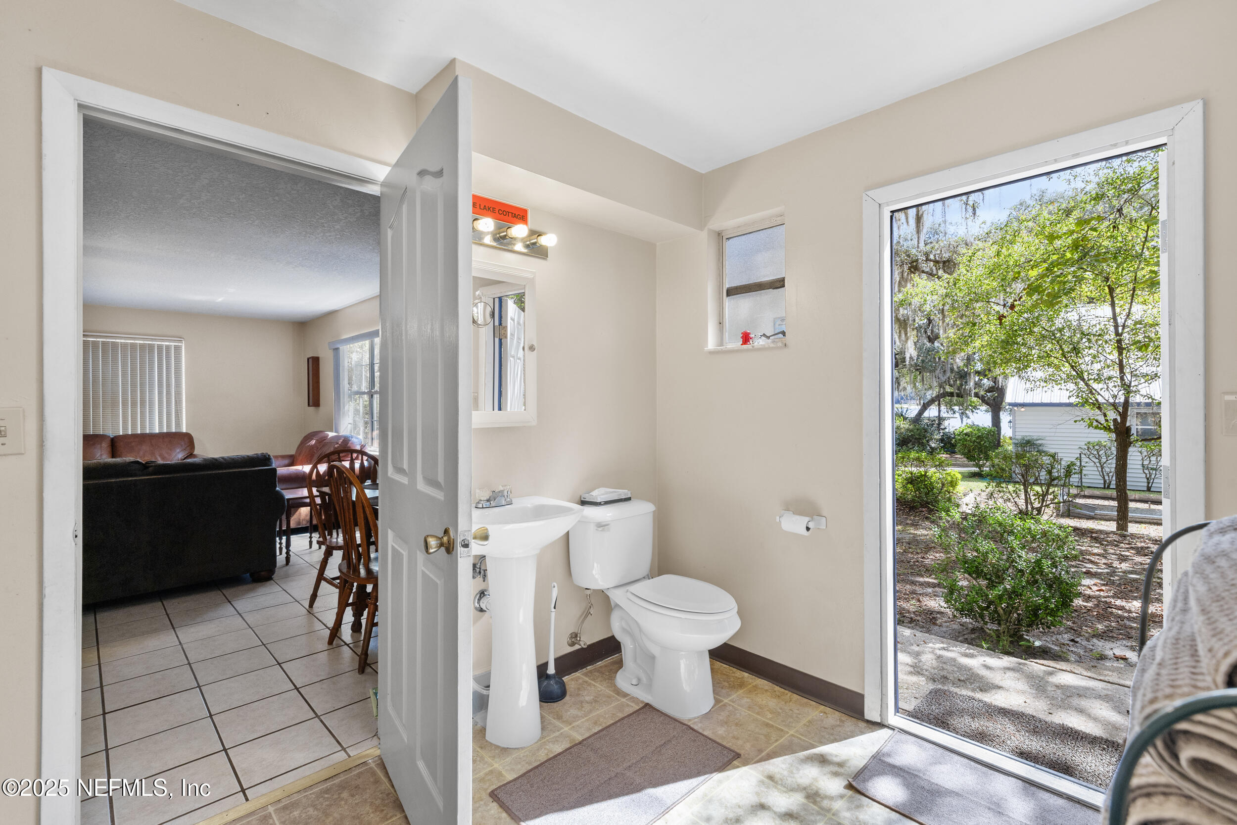 6441 Baker Road Keystone Heights, FL 32656 - Photo 25 of 66 a very nice looking room with a chair and potted plant