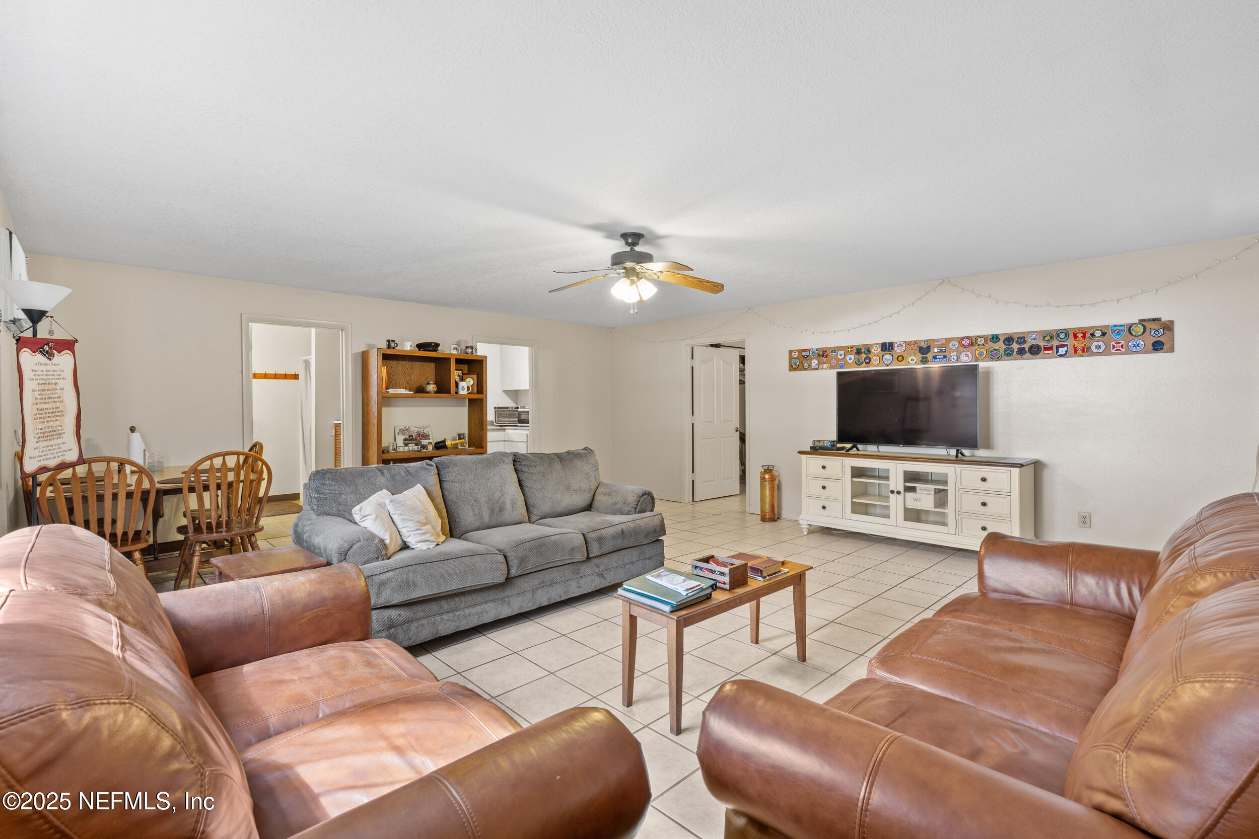 6441 Baker Road Keystone Heights, FL 32656 - Photo 30 of 66 a living room with furniture and a flat screen tv