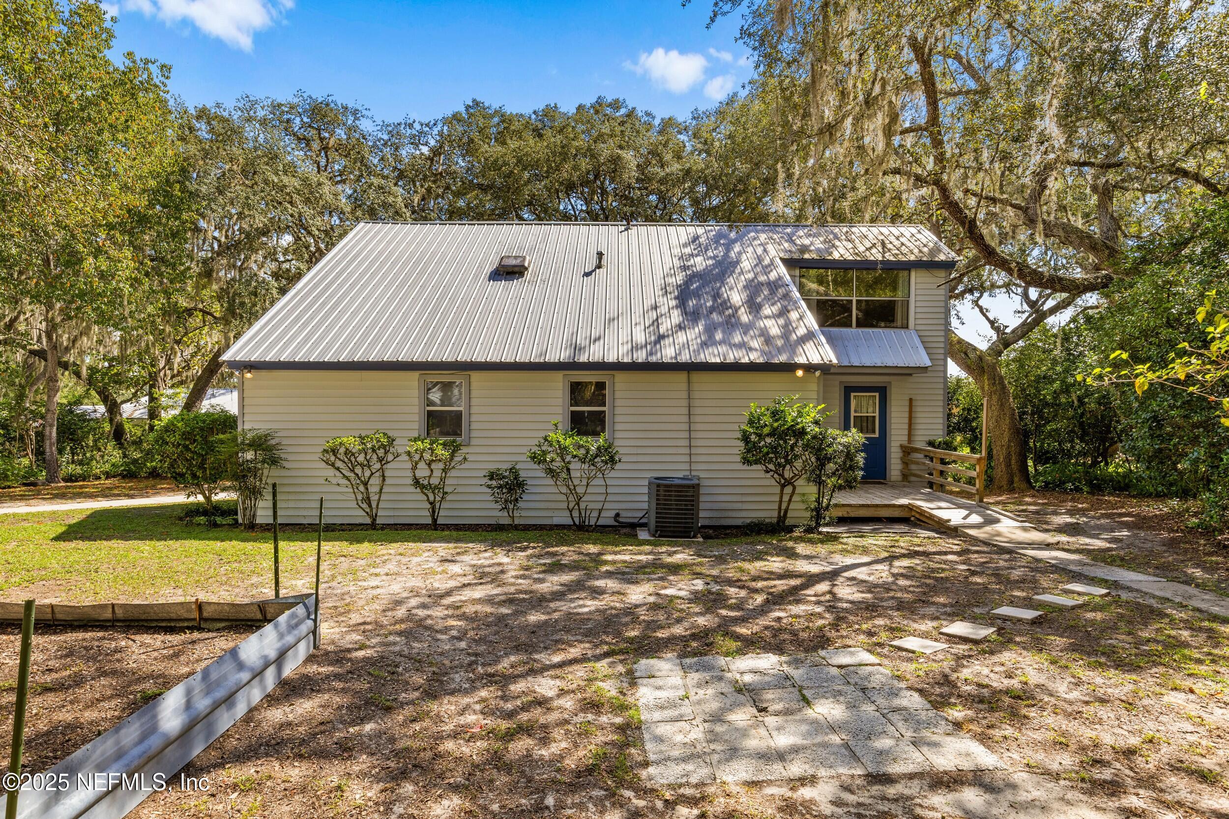 6441 Baker Road Keystone Heights, FL 32656 - Photo 43 of 66 a view of a house with backyard porch and sitting area
