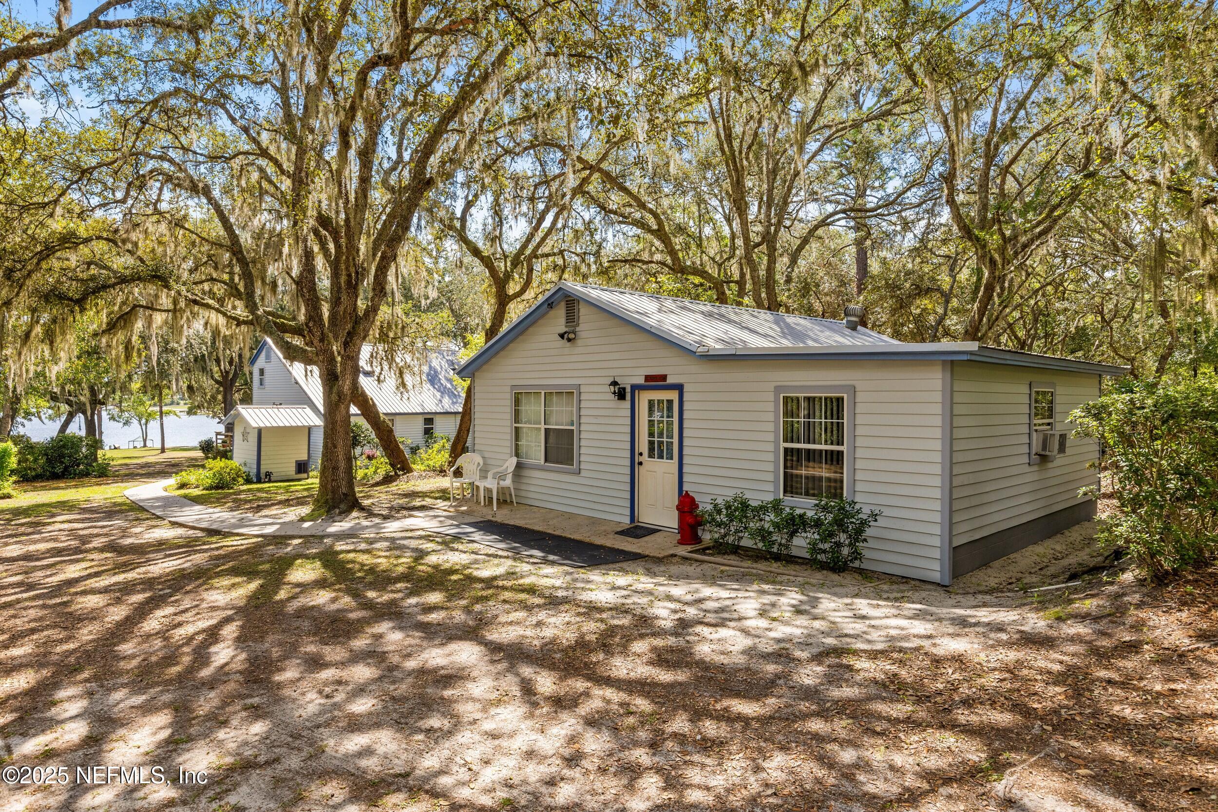 6441 Baker Road Keystone Heights, FL 32656 - Photo 49 of 66 a view of a backyard with a large tree