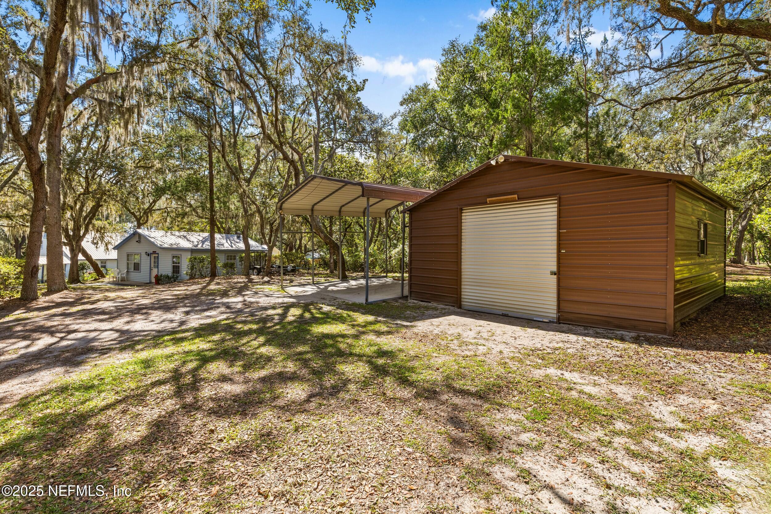6441 Baker Road Keystone Heights, FL 32656 - Photo 51 of 66 a front view of a house with a yard and garage