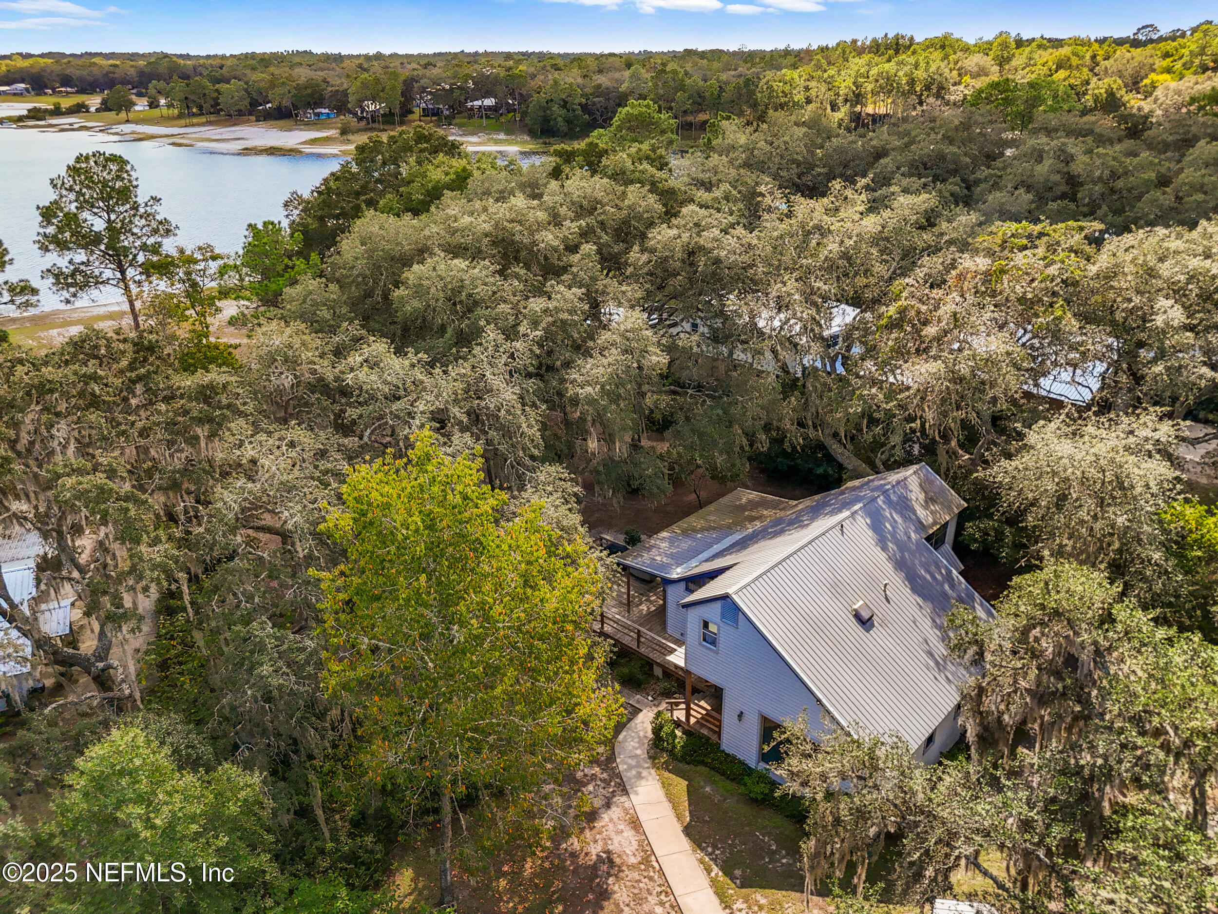 6441 Baker Road Keystone Heights, FL 32656 - Photo 53 of 66 an aerial view of a house with a lake view