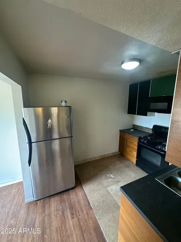 a kitchen with stainless steel appliances a refrigerator stove and sink