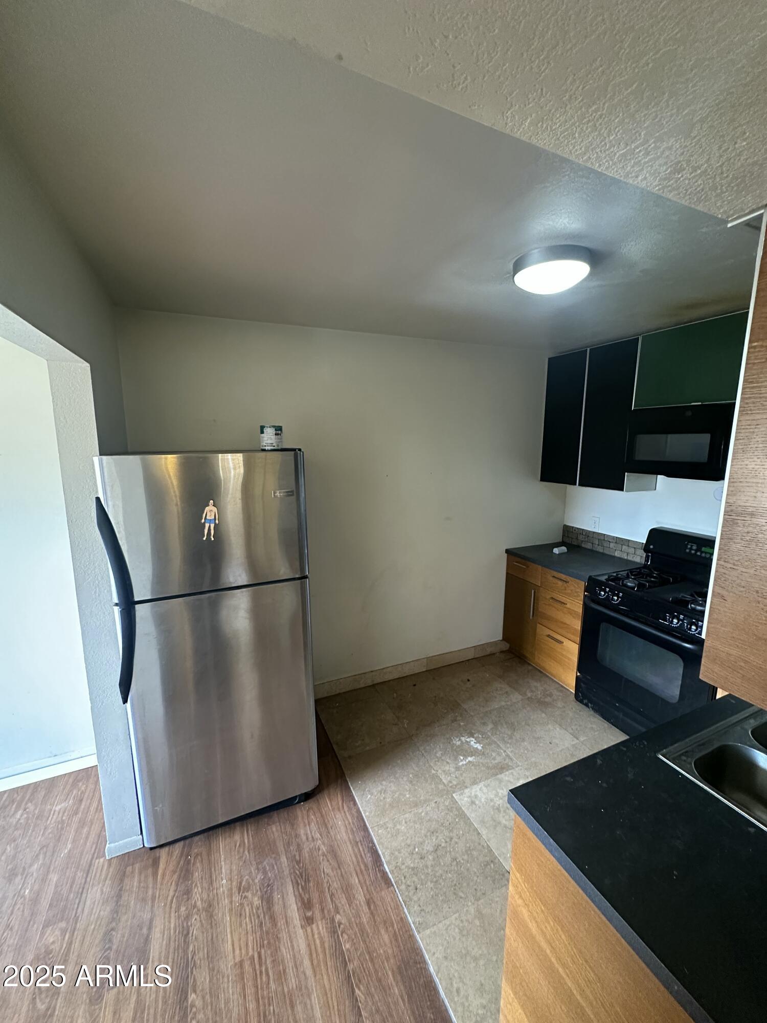 828 West 2nd Street, Unit C Tempe, AZ 85281 - Photo 6 of 15 a kitchen with stainless steel appliances a refrigerator stove and sink