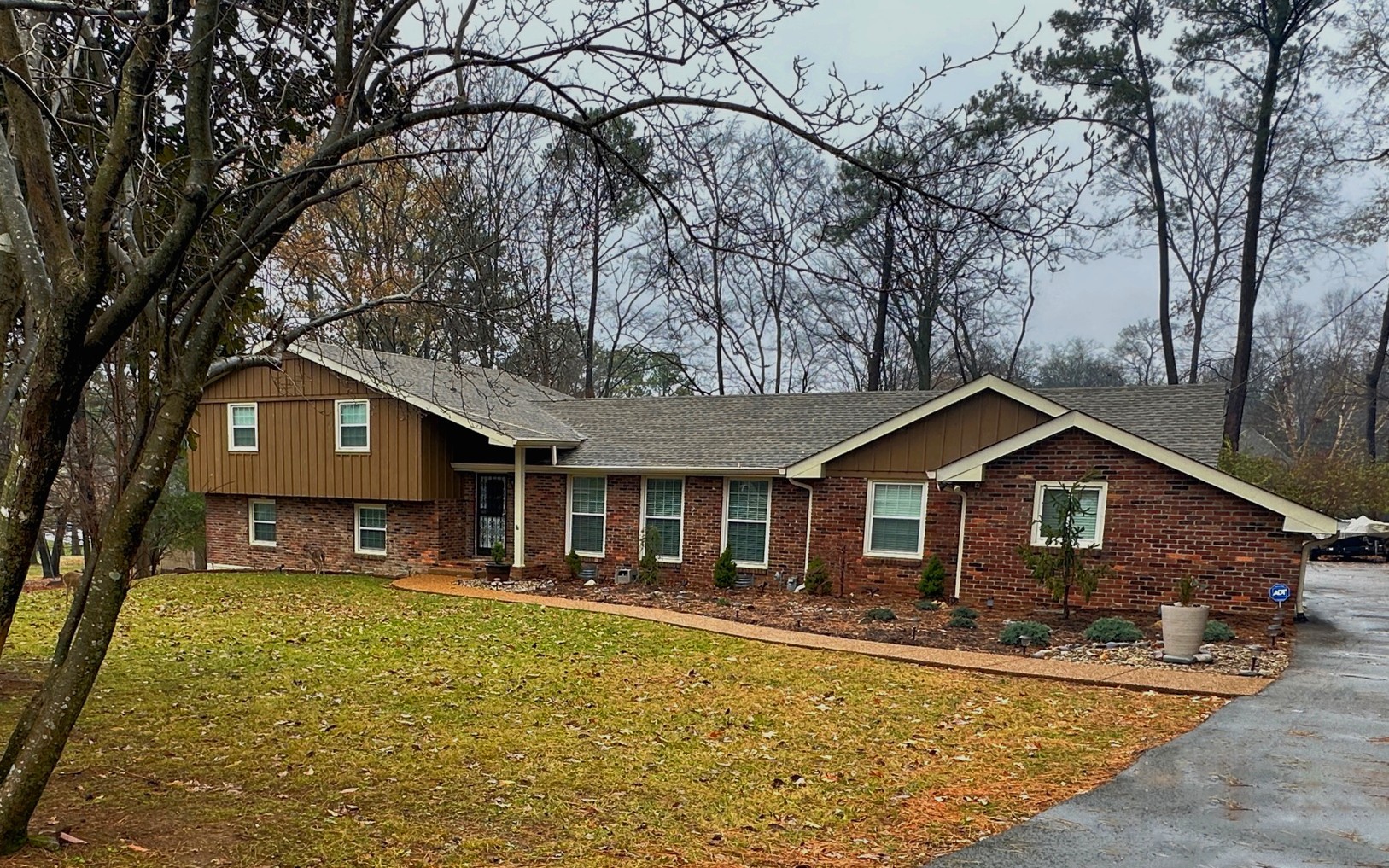 303 Raintree Drive Hendersonville, TN 37075 - Photo 1 of 36 a front view of a house with a yard outdoor seating and garage