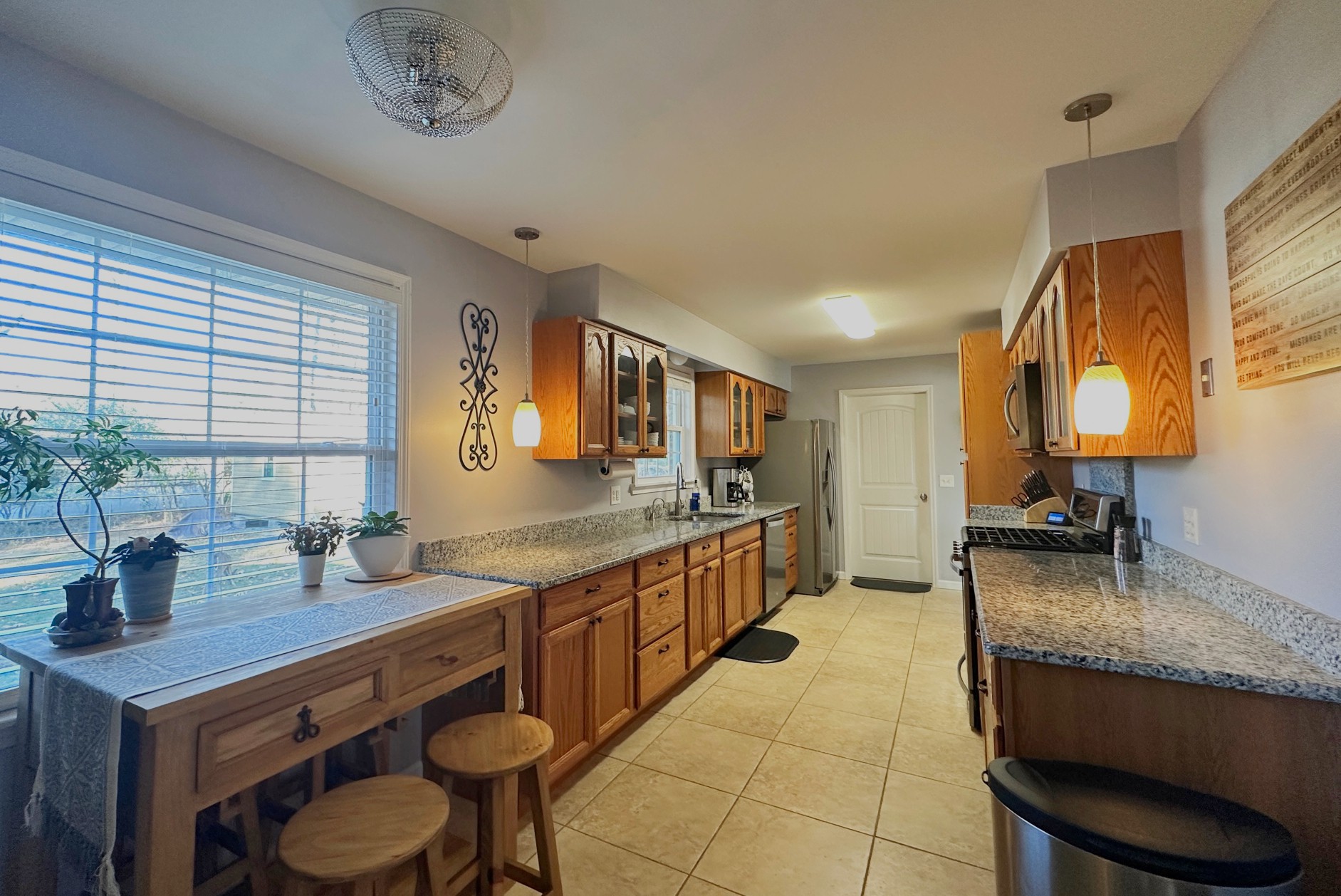 303 Raintree Drive Hendersonville, TN 37075 - Photo 20 of 36 a kitchen with stainless steel appliances granite countertop a sink a stove and a wooden cabinets