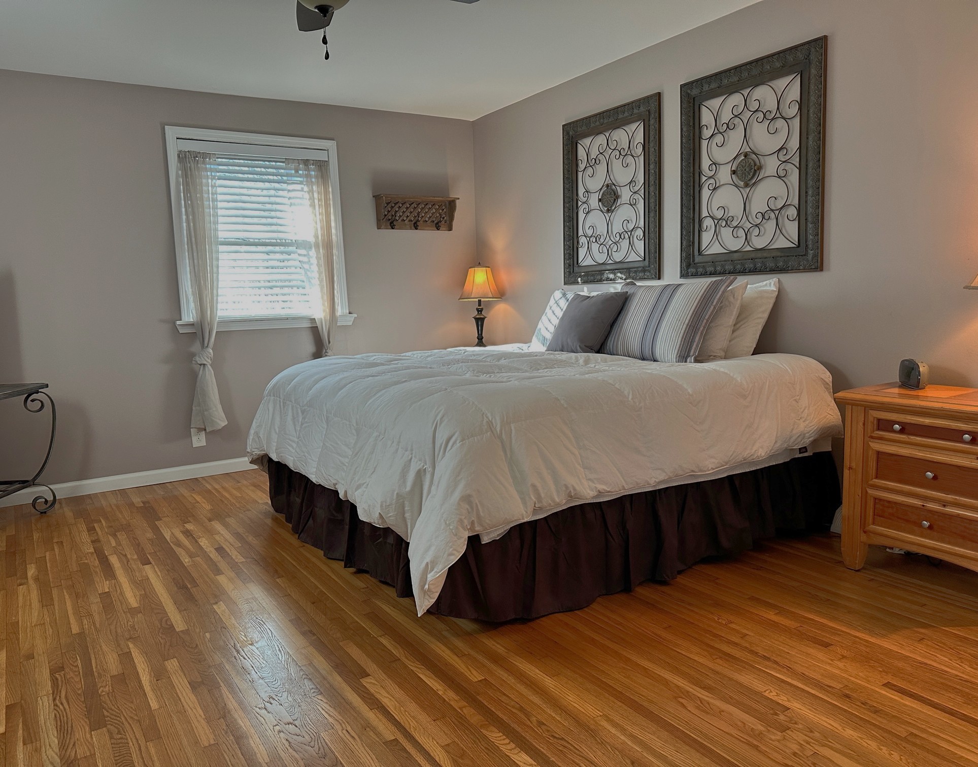 303 Raintree Drive Hendersonville, TN 37075 - Photo 30 of 36 a bedroom with a bed paintings on the wall and a window