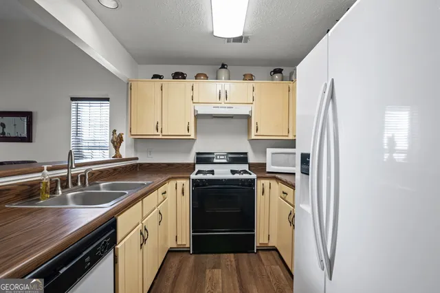 a kitchen with a stove sink and refrigerator