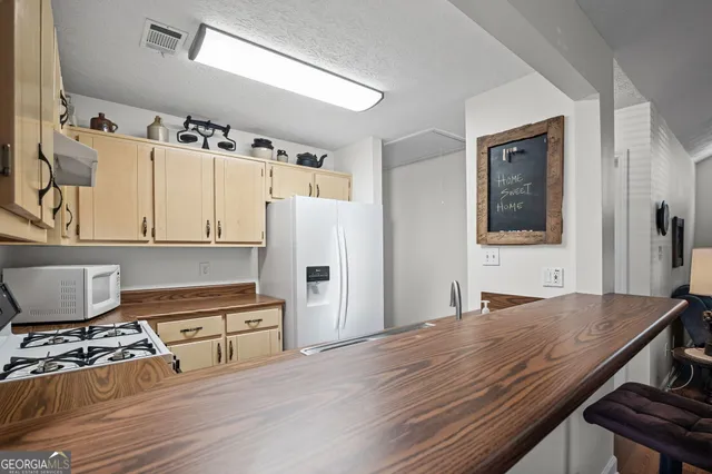 a kitchen with stainless steel appliances granite countertop a stove and a refrigerator