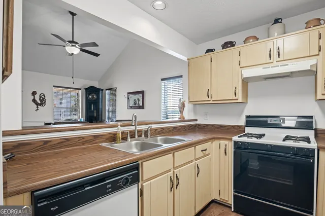 a kitchen with stainless steel appliances sink and cabinets