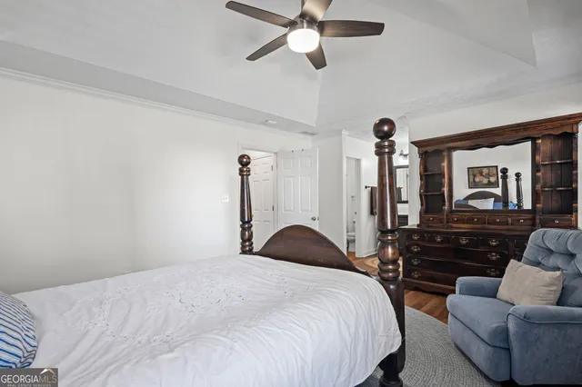 a bedroom with a bed couch and a window