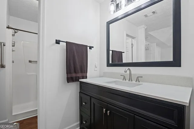 a bathroom with a sink a vanity and a mirror