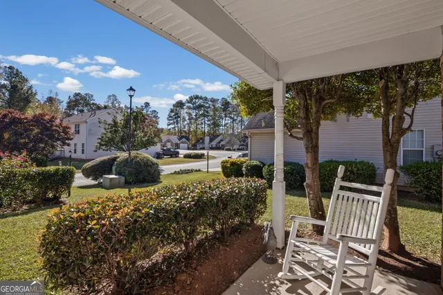 a view of a chair and tables back yard of the house