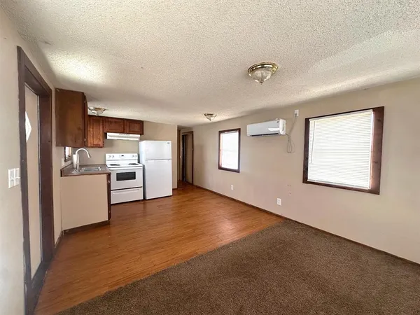 a kitchen with stainless steel appliances granite countertop a refrigerator sink and stove
