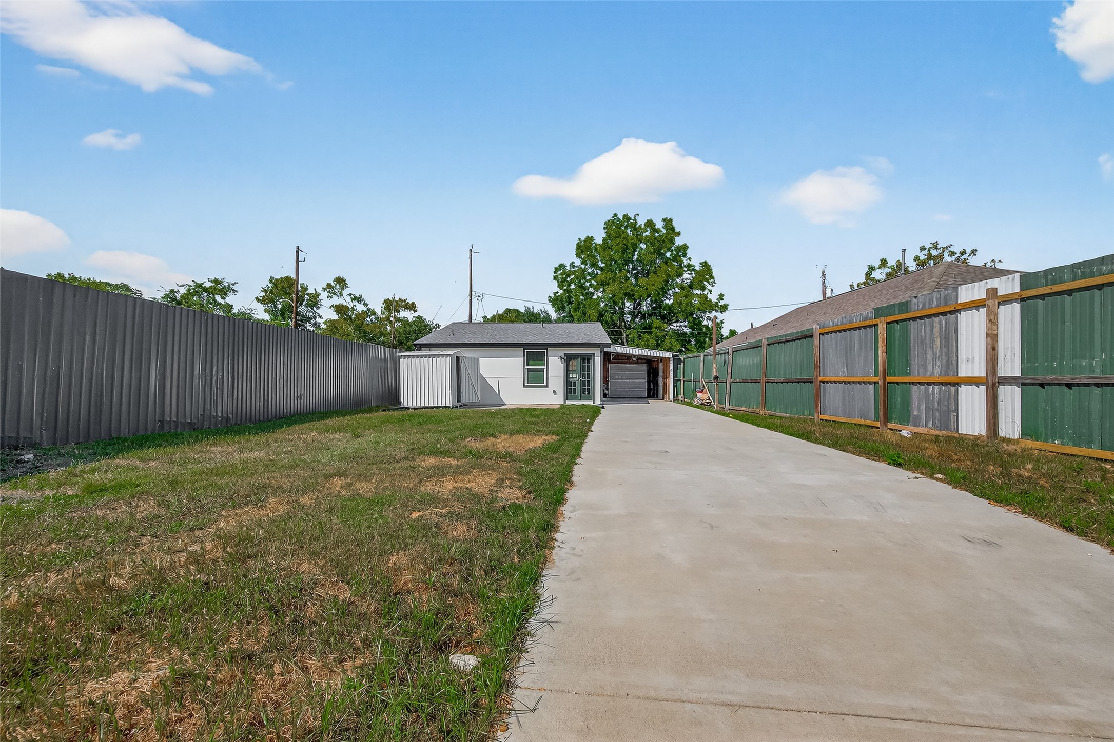 889 Chas Lane Houston, TX 77091 - Photo 3 of 32 a view of a white house in front of a yard with iron fence