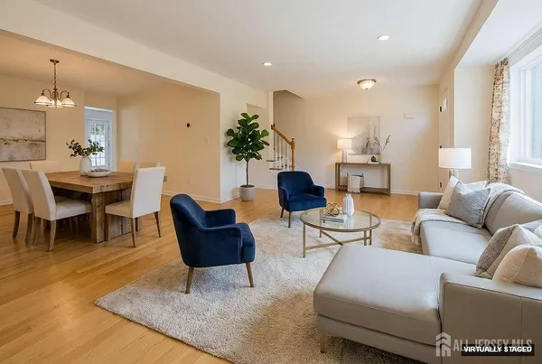 a living room with furniture and a chandelier