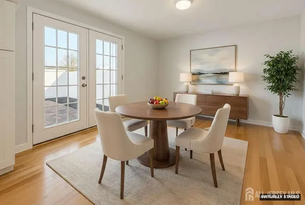 a dining room with furniture and wooden floor