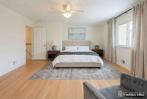a bedroom with a large bed and a chandelier