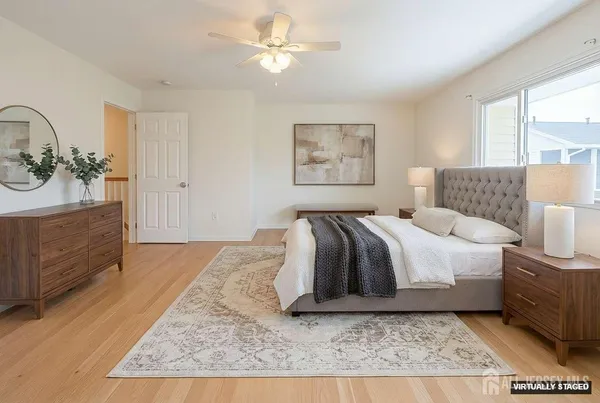 a spacious bedroom with a bed a dresser and a window