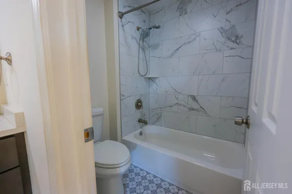 a bathroom with a bathtub and a toilet