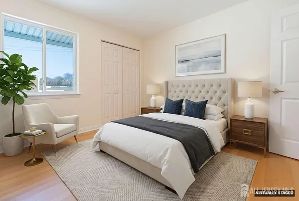a bedroom with a bed and a potted plant