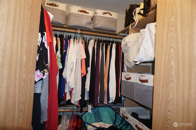 a view of walk in closet with clothes