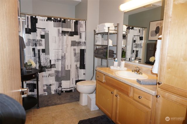 a spacious bathroom with a shower sink and mirror