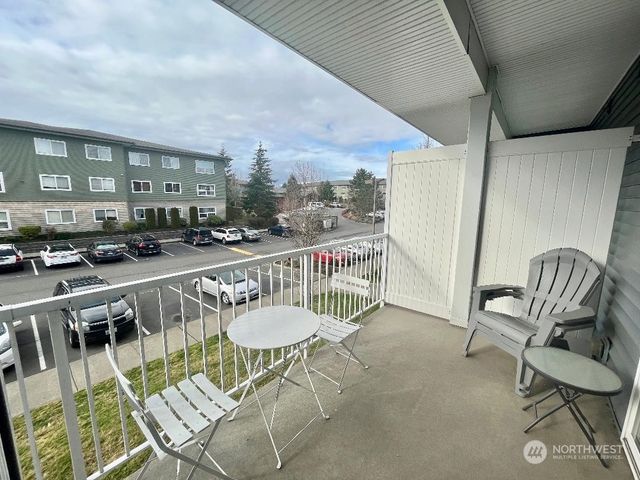 a balcony with table and chairs