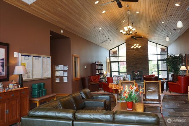 a living room with furniture a chandelier and a dining table