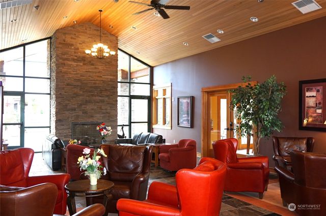 a living room with furniture a floor to ceiling window and a flat screen tv