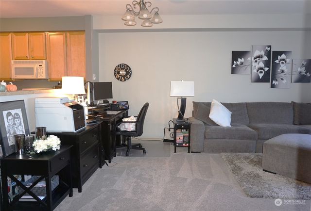 a view of a livingroom with furniture and a window