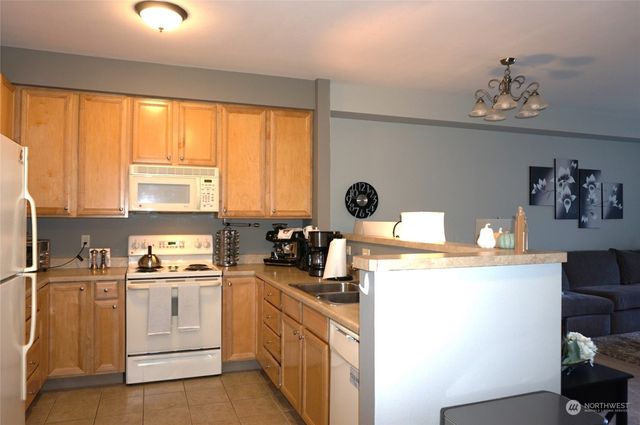 a kitchen with a sink and a stove top oven