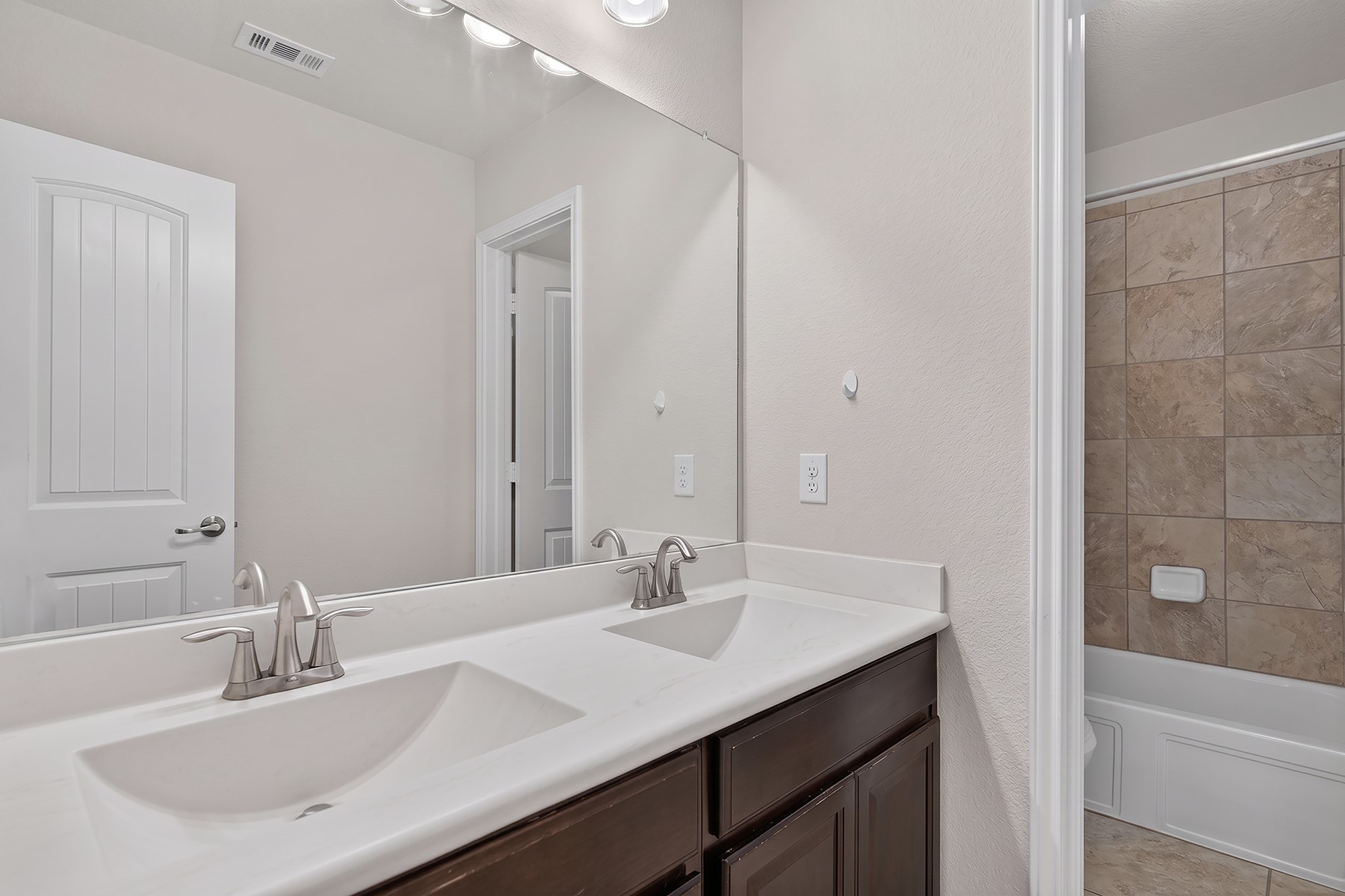 4601 Chestnut Meadows Bend Georgetown, TX 78626 - Photo 22 of 35 Double vanity sinks and an ample mirror characterize this pristine bathroom.