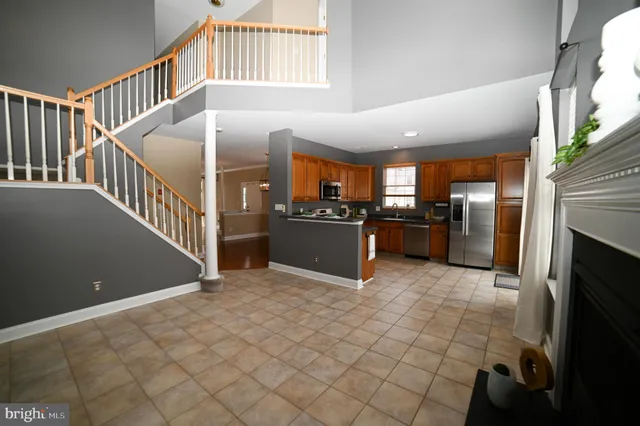 a view of a kitchen with furniture and an empty room